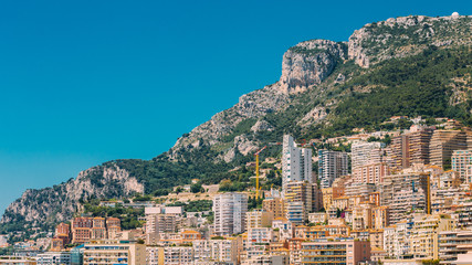 Fototapeta na wymiar Monaco, Monte Carlo architecture on mountain hill background. Ma