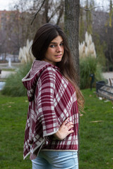 Blue-eyed young model posing in a fashion shoot in the park. 