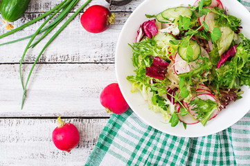 Fresh salad of cucumbers, radishes and herbs. Top view