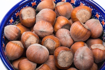 Pile of hazelnuts isolated on white background
