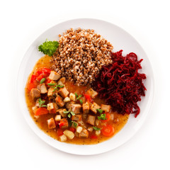 Roasted meat, white grits and vegetables 