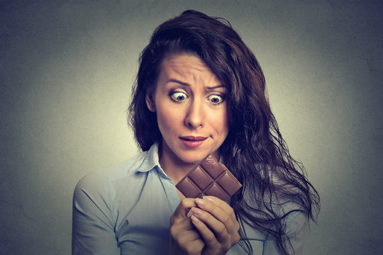 young woman tired of diet restrictions craving sweets chocolate