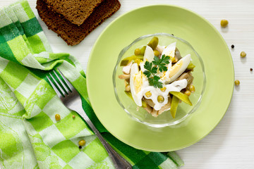 Salad with meat, mushrooms, pickles and green peas