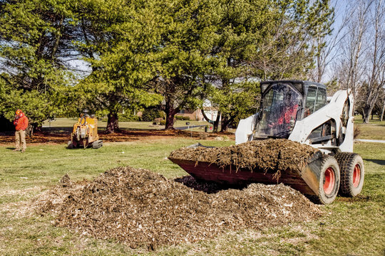 Dozer Being Used By Landscapers To Remove Chips And Debris After Tree Stump Was Grinded Out.
