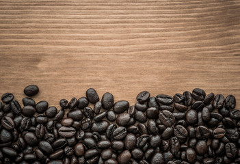 background of brown coffee beans on wood board