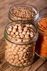 Glass full of chickpeas and next two with other legumes