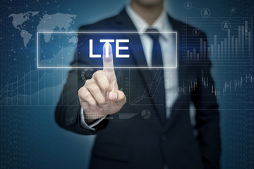 Businessman hand touching LTE  button on virtual screen