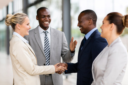 african man introducing businesswoman to business partners