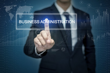 Businessman hand touching BUSINESS ADMINISTRATION  button on vir