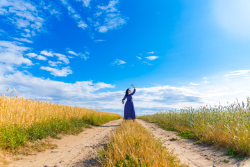 Beautiful brunette woman in wheat field