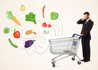 Businessman with shopping cart with vegetables