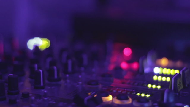 Close-up video of female dj hands playing music at the nightclub. Mixing console