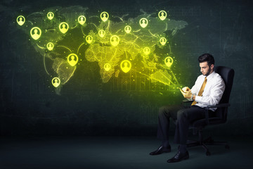 Businessman in office with tablet and social network world map