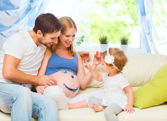 happy family in anticipation of baby. Pregnant mother, father an