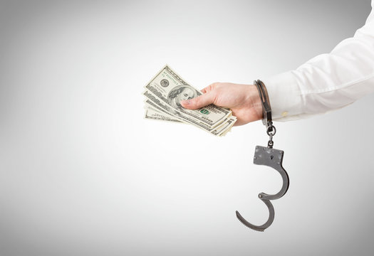 Hand With Money In Handcuffs