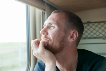   guy  by   window in   train.