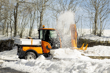 snow blower machine vehicle working  removing  the snow from the highway