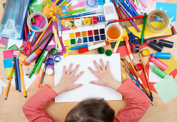 Naklejka premium Child drawing top view. Artwork workplace with creative accessories. Flat lay art tools for painting.