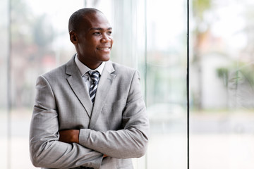 black businessman looking outside window