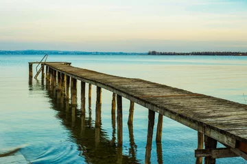 Fotobehang Wooden dock at lake © matteosan