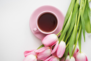 Fototapeta na wymiar fresh spring pink tulips with tea on white background