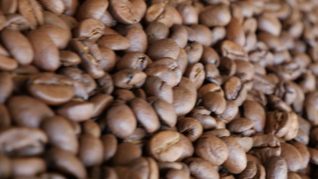 High quality Arabica coffee beans on table filmed with dolly slider 4K 2160p 30fps UltraHD video - Arabic type roasted coffee beans slow sliding dolly 4K 3840X2160 UHD footage 