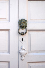 Old handle on the wooden door in Santa Cruz de la Palma city in Spain. Architectural detail close-up view.