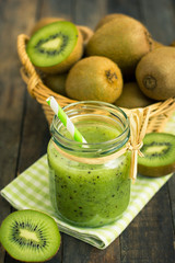 Fresh kiwi smoothie and fruit on the table