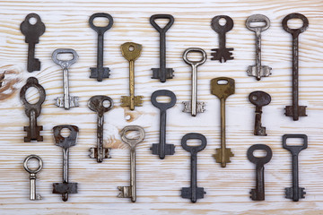 Old keys on wooden background