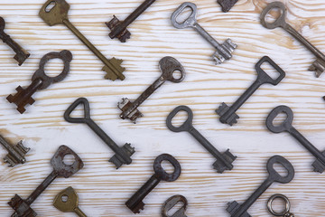 Old keys on wooden background
