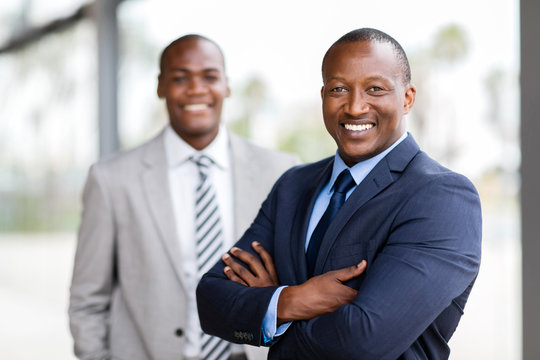 african businessman standing in front of colleague