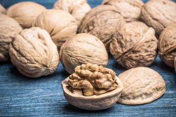 Walnuts on grunge blue wooden table.