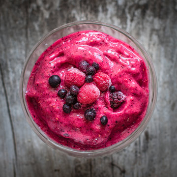 red smoothie with frozen berries, selective focus, top view