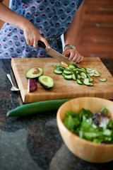 Mature woman chopping vegetables