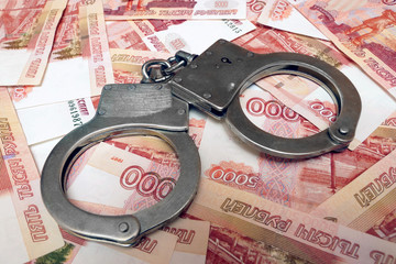 Banknotes and metal handcuffs