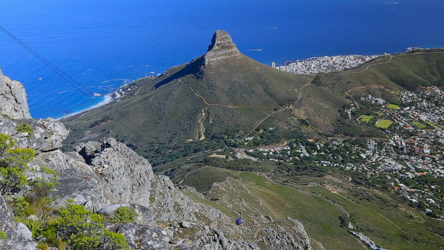 Republic of South Africa. Cape Town (Kaapstad). Panoramic ocean view of the city, Lion's Head, Signal Hill and Robben Island in the background. Table Mountain Cableway with riding cable car to the top