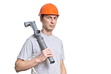 the young working plumber with the tool