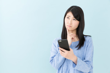 attractive asian woman on blue background