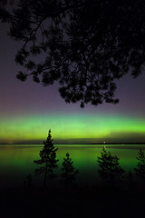 Northern lights over lake in finland