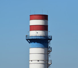 Wide chimney at the plant for the processing of scrap metal
