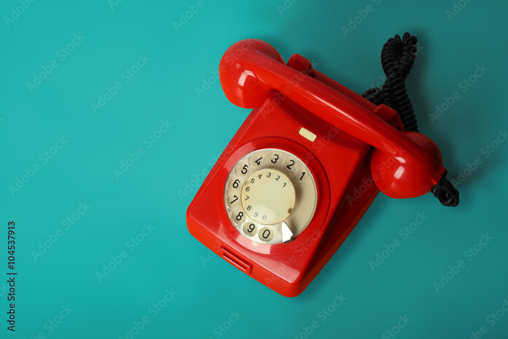 Wall mural red vintage phone on a blue background