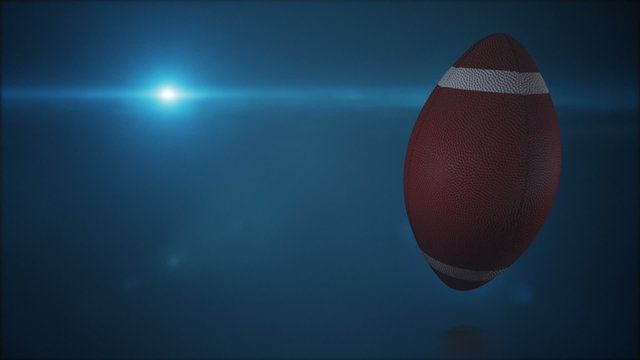 American football rotating on blue background whit lens flare, loop animation.