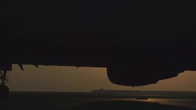 An Air Force KC-10 taxis against the sun on the tarmac of a military base.