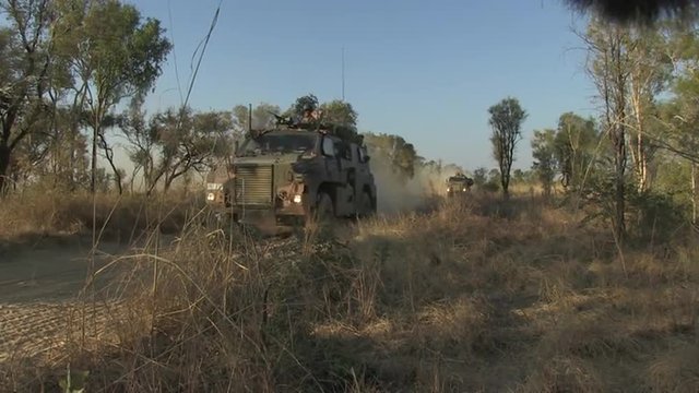 Australian Defense Forces Troops Move Through The Outback With Armored Personnel Carriers.