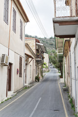 Fototapeta na wymiar Vanishing street with vintage buildings. Pano Lefkara, Cyprus. 