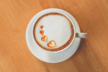 latte coffee in life on brown wood table. 