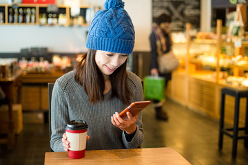 Woman use of cellphone at cafe