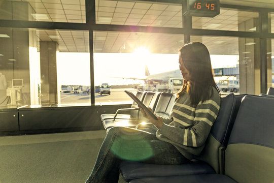 Passenger Traveler Woman In Airport Use Of Tablet At Departure H