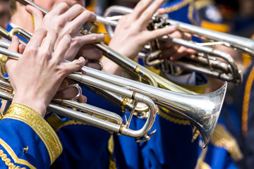 young musicians plays on trumpets on street concert