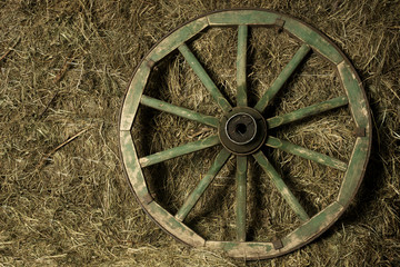 the wheel of the cart in a haystack